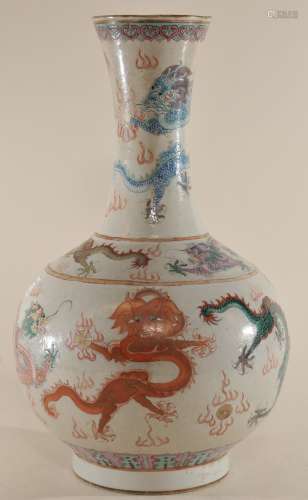 Porcelain vase. China. 19th century. Bottle form. Decoration of various coloured dragons on a wave pattern scraffitto ground. Ch'ien Lung cartouche on the base flanked with dragons. 15-1/2