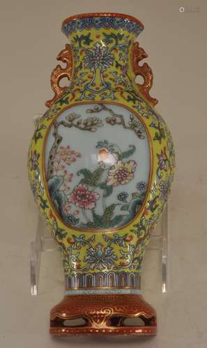 Wall vase. China. Ch'ien Lung mark but probably 19th century. Fen Tsai palette. Reserve decoration of flowers on a floral scroll lemon yellow ground. Phoenix handles and stand of orange with gilt. 8-1/2