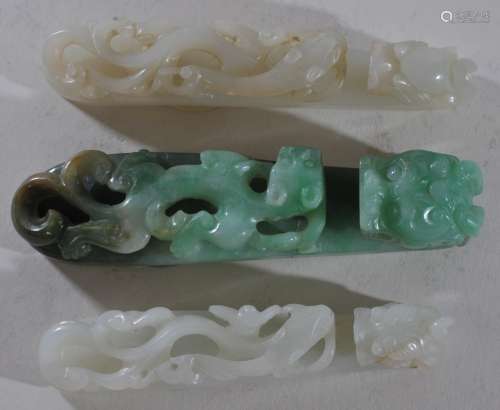 Three Jade garment hooks. China. 19th century. Chih Lin carving with dragon heads. Two white, one green. Two with fissures. Largest- 4