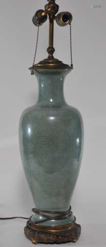 Porcelain vase. China. 19th century. Baluster form. Celadon glaze. Drilled for a lamp. 17