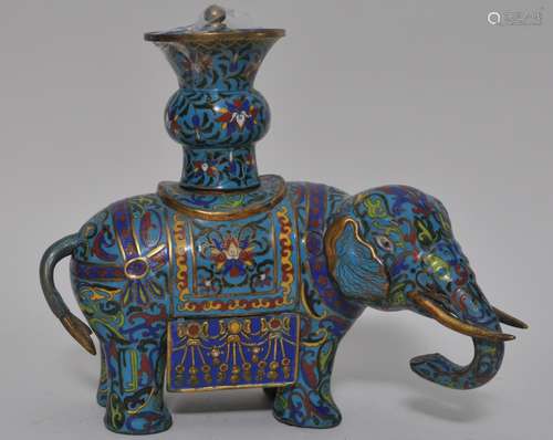 Cloisonne Elephant. China. 20th century. Caparisoned with a covered vase at the back. 12