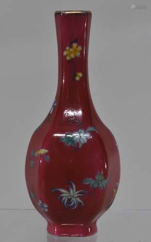 Porcelain vase. China. Early 20th century. Hexagonal form. Magenta ground with Famille Rose flowers. Ch'ien Lung mark. 6