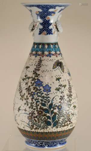 Cloisonne porcelain vase. Japan. Meiji period. (1868-1912). Decoration of butterflies and flowers. Molded decoration of flowers with underglaze blue and red accents. Inscription on the base. 11-1/2