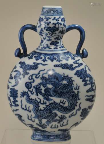 Porcelain vase. China. 19th century. Pilgrim flask with ju-i handles. Ming style decoration of dragons, pearls, bats and clouds in underglaze blue. 9-1/2