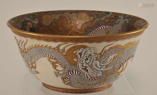 Pottery bowl. Japan. Meiji period (1868-1912). Satsuma ware. Interior decoration of The Hundred Buddhist Saints. Exterior with white dragons and Satsuma heraldic emblems. Chip. Signed. 7-3/4