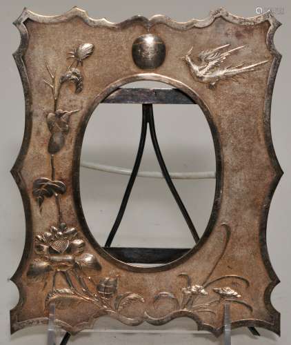 Chinese Export silver frame. Early 20th century. Repousse decoration of birds and flowers on a fish roe ground. Signed. 7