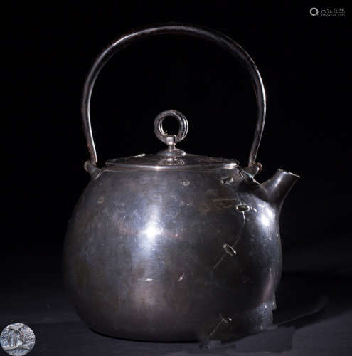 AN IRON TEAPOT WITH PATTERNS