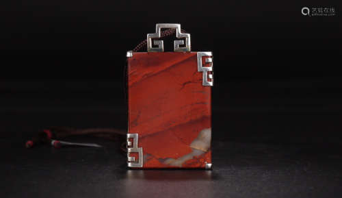 A SOUTHERN RED AGATE PENDANT EMBEDED SILVER SIDE