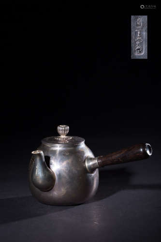 A GILT SILVER TEAPOT WITH PATTERNS