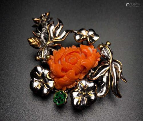 A MOMO RED CORAL WITH SILVER BROOCH