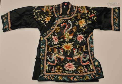 Silk Robe. China. Early 20th century. Black ground with teal borders. Embroidery of phoenixes, flowers and shou characters. Some loss.