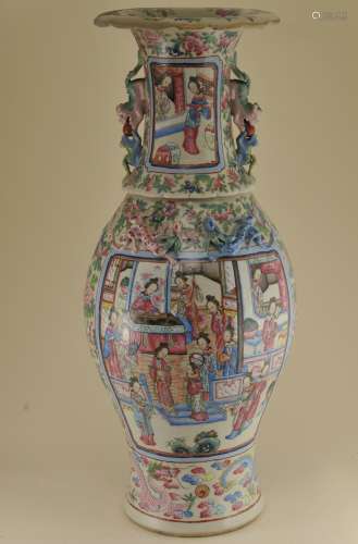 Porcelain vase. China. 19th century. Foo dog handles. Famille Rose reserve decoration of women. Ground of dragons, phoenixes and flowers. Extensive repairs. 24-1/2