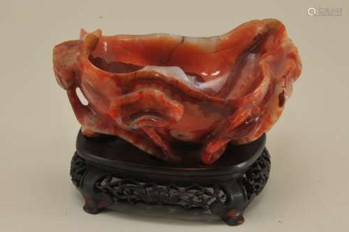 Agate water coupe. China. 19th century. Red and white stone. Carved as a lotus leaf with flowers and seed pods. 4-1/4