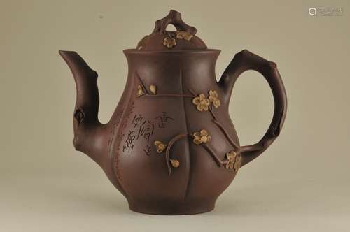 19th/20th century Yixing pottery large lobed teapot with incised landscape decoration on one side and raised floral branch and poem on the other side. Floral decorated cover. Branch handle and spout. Signed inside cover and on base. Good condition.  7-3/4