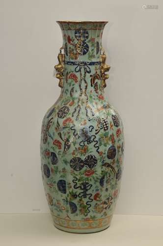 Porcelain vase. Chinese Export ware. 19th century. Sculpted in the form of a tied money bag. Foo dog handles. Decoration in underglaze blue and Famille rose enamels. Design of brocade spheres, auspicious emblems, birds, flowers and butterflies. Repair to one side. 25-1/4