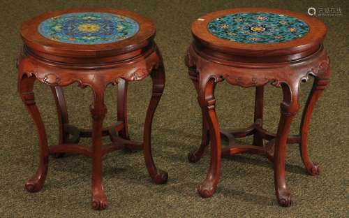 Pair of stools. China. 20th century. Carved rosewood inset with floral decorated cloisonné plaques. 19