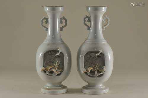Pair of porcelain vases. Japan. 19th century. Probably Hirado ware. Deeply carved sides with high relief elements of flowering trees. 6-3/4