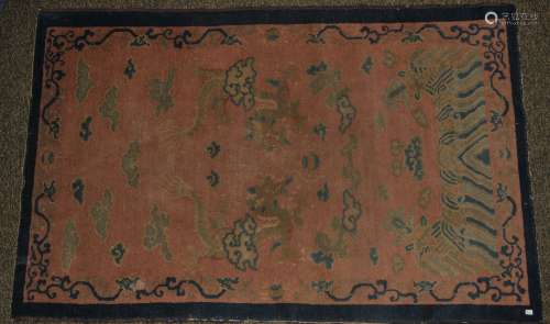 Antique 19th century Chinese Scatter Rug with peach ground. Decorated with dragons and clouds. 37