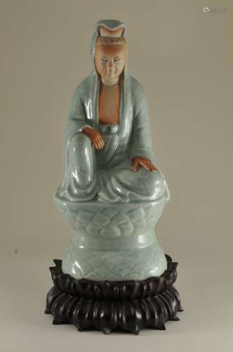 19th century Chinese carved celadon glaze figure of a seated Quan Yin. Floral and lotus decoration. Unglazed biscuit face and hand. Carved wooden base. Height of figure- 12