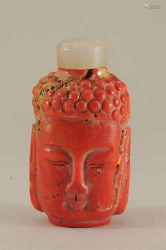 Coral snuff bottle. Carving of the faces of the Buddha's. 2-1/4
