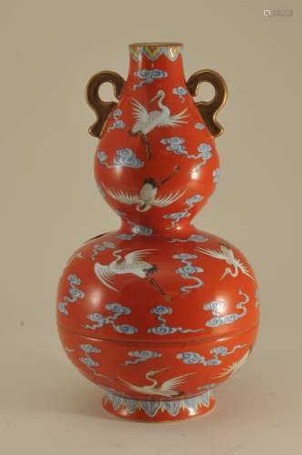 Porcelain vase. China. Republic period. Circa 1920. Two sectional double gourd form. Decoration of cranes and clouds on an orange ground. Gilt handles. Ch'ien Lung mark on the base. 8