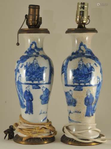 Pair of porcelain vases. China. Late 19th to early 20th century. Underglaze blue decoration of figures in landscapes on a crackled white ground. 11