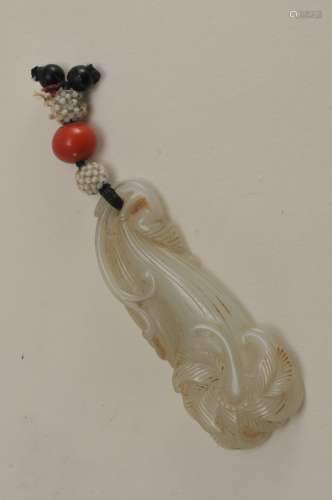 Jade pendant. China. 19th century. Greyish white stone. Carving of flowers and foliage. Mouned with seed pearls and coral. 2-1/4