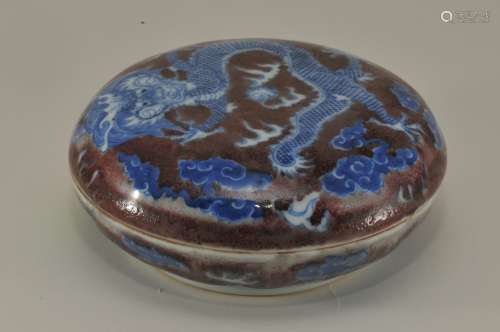 Porcelain incense box. China. Late 19th to early 20th century. Underglaze blue and red decoration of dragons, pearls and clouds. Round form. 5