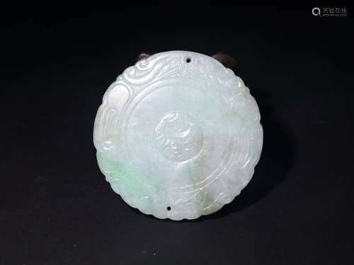 A JADEITE CIRCULAR PENDANT OF CHILD