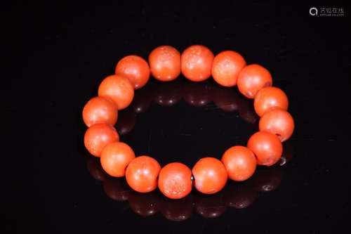 A BRACELET MADE OF RED AGATE BEADS