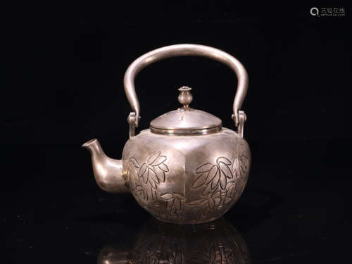 A SILVER TEAPOT WITH BAMBOO PATTERNS