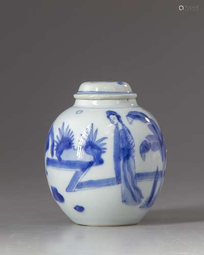 A small blue and white jar and cover