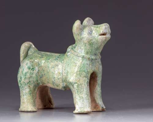 A green glazed pottery figure of a dog