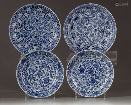 Four blue and white saucers