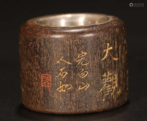 A CHENXIANG WOOD CARVED SILVER DECORATED RING