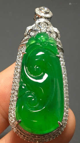 A GREEN JADEITE CARVED AUSPICIOUS PENDANT, A CLASS