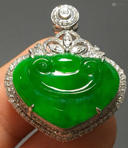 A GREEN JADEITE CARVED AUSPICIOUS PENDANT, A CLASS