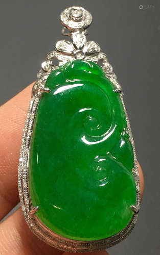 A GREEN JADEITE CARVED AUSPICIOUS PENDANT, A CLASS