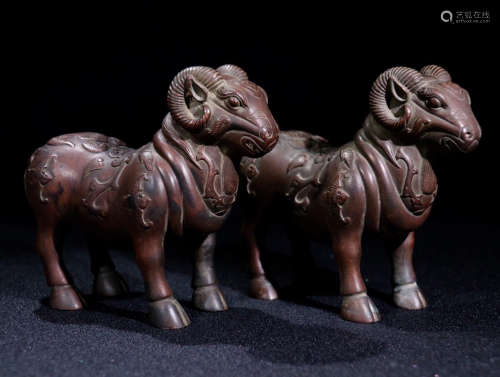 A PAIR OF BRONZE ORNAMENTS OF SHEEP SHAPED
