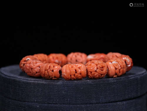 A RED CORAL BRACELET WITH FLORAL PATTERN