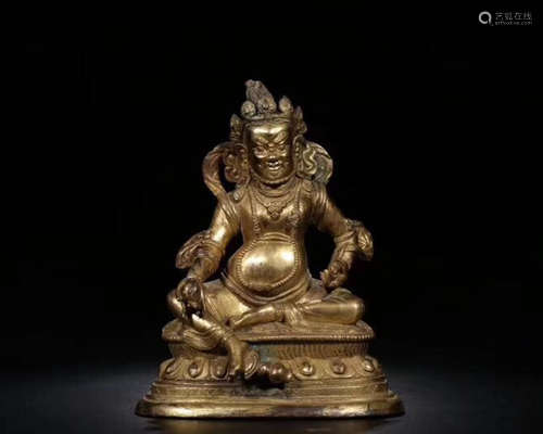 A GILT BRONZE CARVED WEALTH BUDDHA