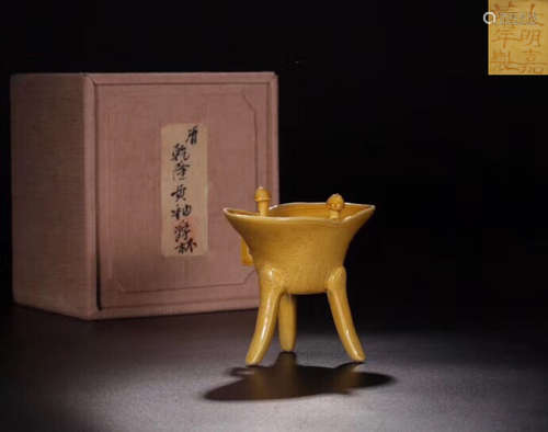 A YELLOW GLAZED VESSEL WITH MARKING