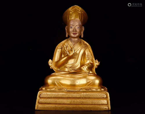 A GILT BRONZE BUDDHA SITTING ORNAMENT