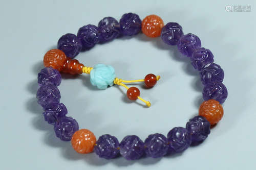 A BRACELET MADE OF PURPLE CRYSTAL BEADS