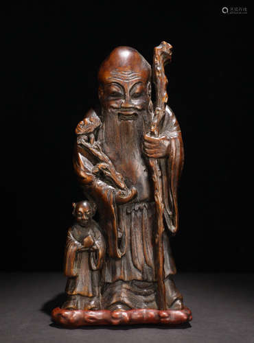 A CHENXIANG WOOD CARVED FIGURE SHAPED PENDANT