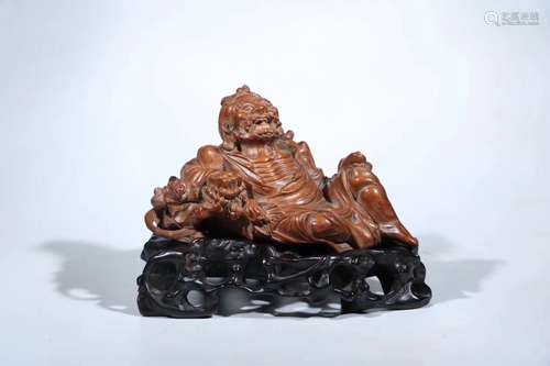 A HUANGYANG WOOD CARVED FIGURE SHAPED PENDANT