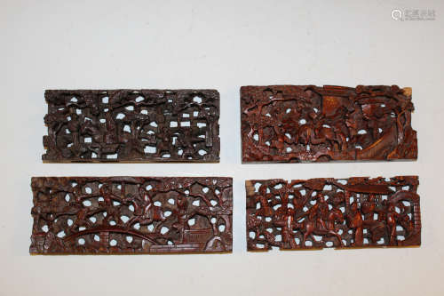 Set of four Chinese carved wood panels.