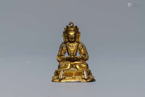 A Sino-Tibetan gilt bronze miniature figure of Buddha, 16/17th C.