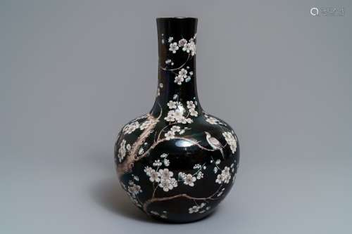 A Chinese famille noire tianqiu ping vase with birds among blossoms, 19th C.