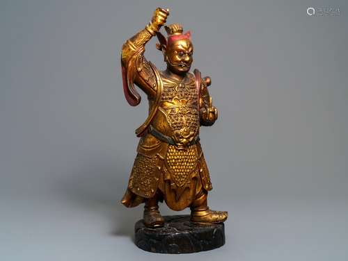 A large Chinese carved giltwood figure of a guardian, 17/18th C.